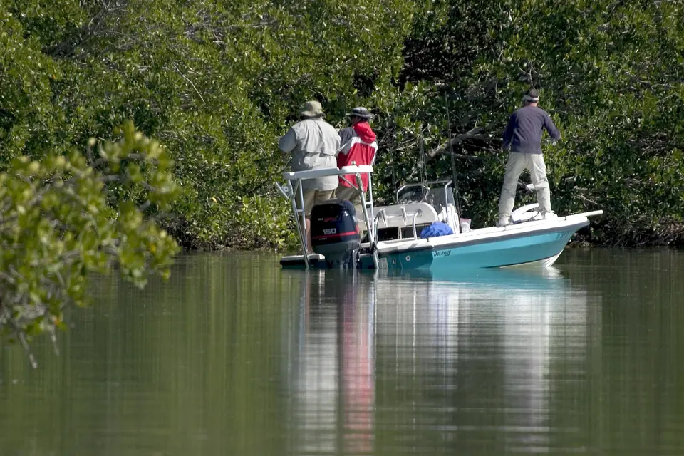 Two anglers fishing from a skiff on the calm water of Florida Bay
